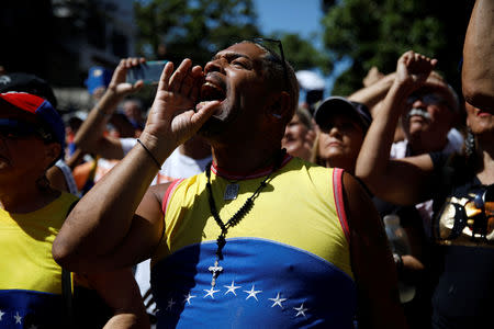 Opposition supporters shout slogans during a gathering with members of Venezuela's National Assembly in La Guaira, Venezuela January 13, 2019. REUTERS/Carlos Garcia Rawlins
