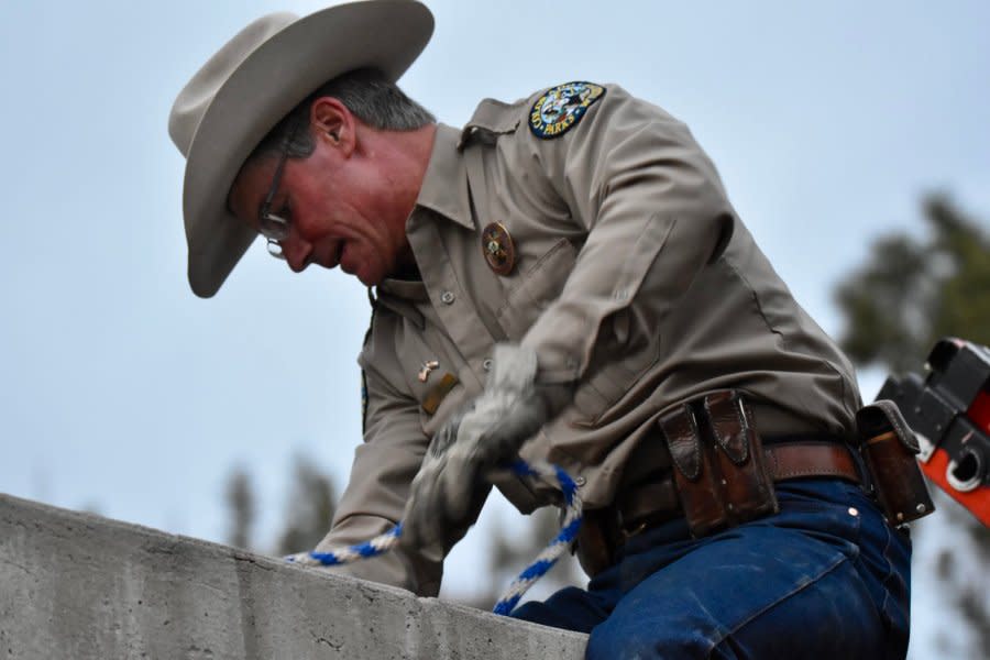 CPW District Wildlife Manager Ty Smith looks into the spillway.