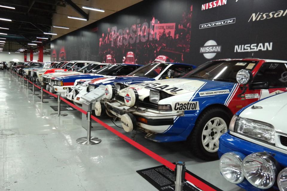 <p>On the west wall of the racing section of the facility sits Nissan's long line of factory rally cars. </p>