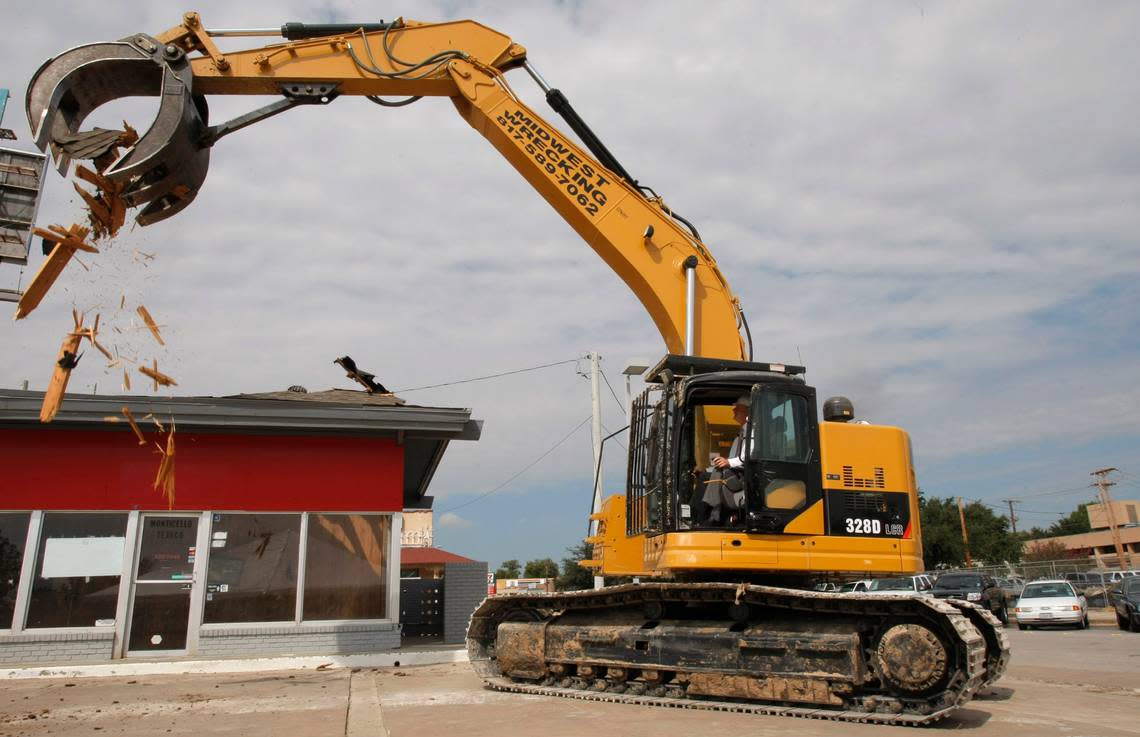 Sept. 19, 2007: Fort Worth Mayor Mike Moncrief drives a excavator to start the demolition of the gasoline station at the corner of Camp Bowie Boulevard and West Seventh Street that had been there since the 1950s. It was the groundbreaking for the Museum Place mixed-use development.