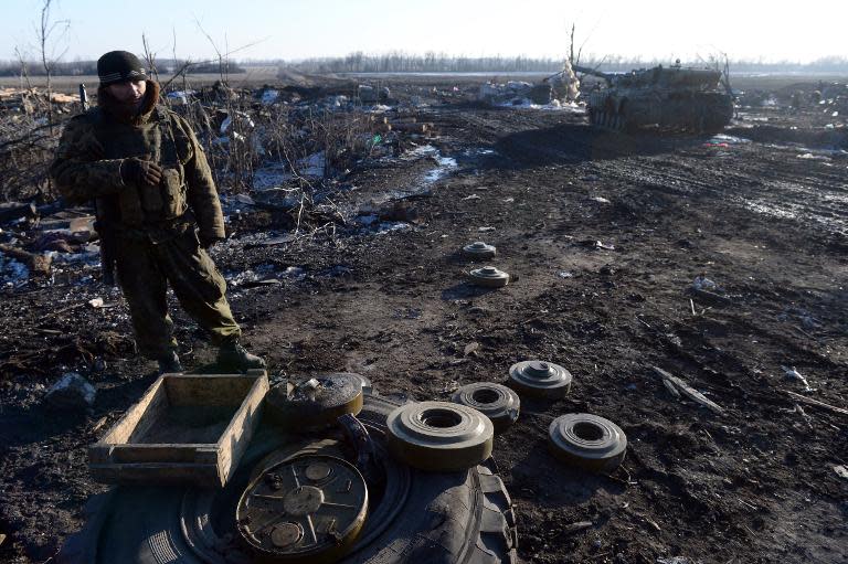 Pro-Russian rebel stand next to mines near the eastern Ukrainian city of Debaltseve in the Donetsk region, on February 20, 2015