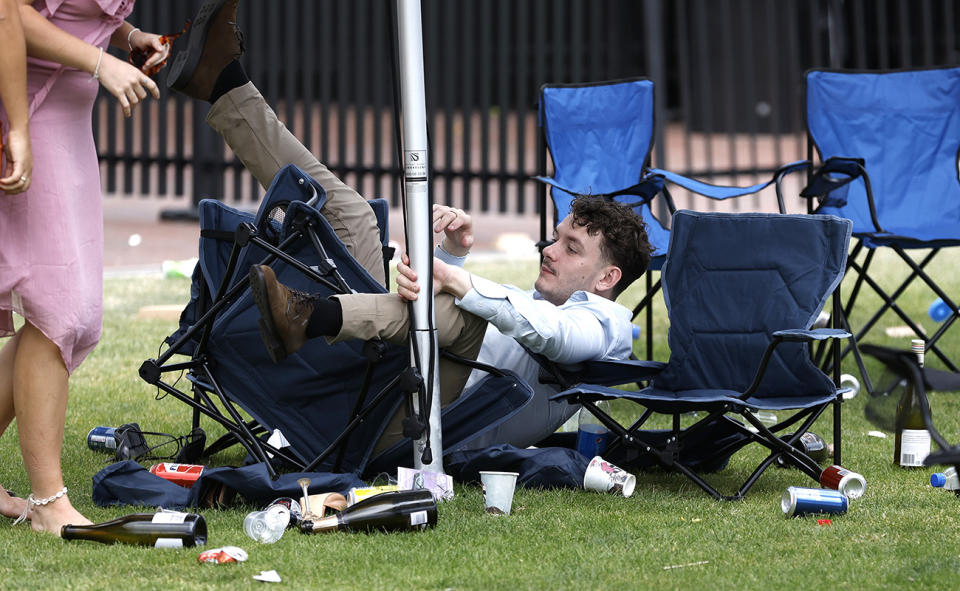 A man falls off a chair at Flemington.