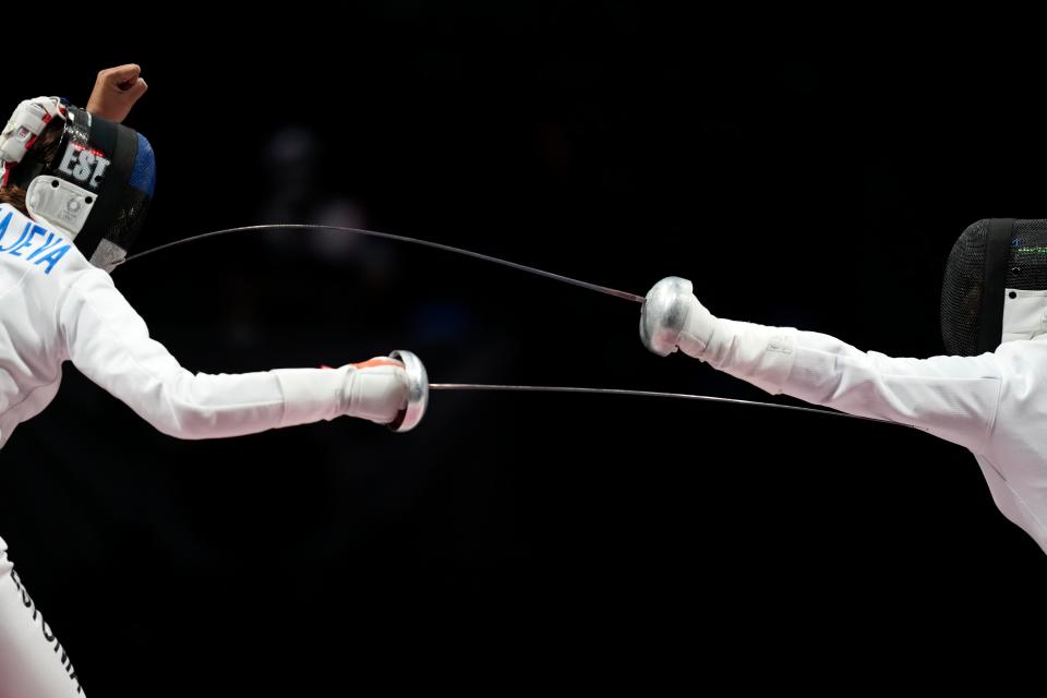 Julia Beljajeva (EST), left, competes with Young Mi Kang (KOR), right, in the gold medal match of the women's fencing epee team competition during the Tokyo 2020 Olympic Summer Games at Makuhari Messe Hall B on July 27, 2021. 
