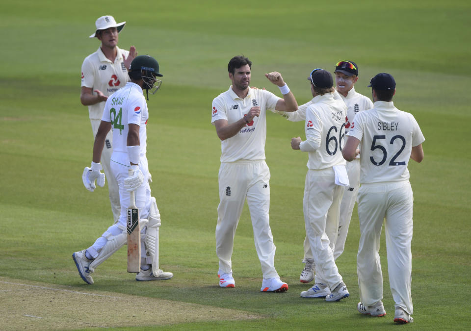 England's James Anderson, third left, celebrates with teammates the dismissal of Pakistan's Shan Masood, second left with bat, during the first day of the second cricket Test match between England and Pakistan, at the Ageas Bowl in Southampton, England, Thursday, Aug. 13, 2020. (Stu Forster/Pool via AP)