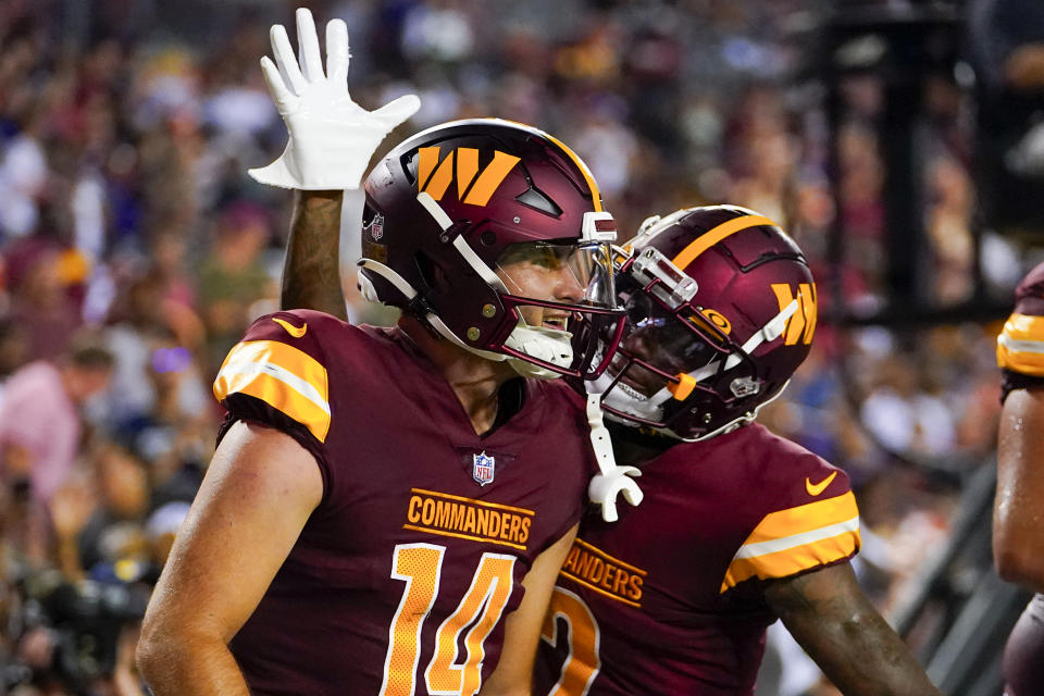 Washington Commanders quarterback Sam Howell, left, and wide receiver Dyami Brown celebrate after connecting for a touchdown during the first half of an NFL preseason football game against the Baltimore Ravens, Monday, Aug. 21, 2023, in Landover, Md. (AP Photo/Julio Cortez)