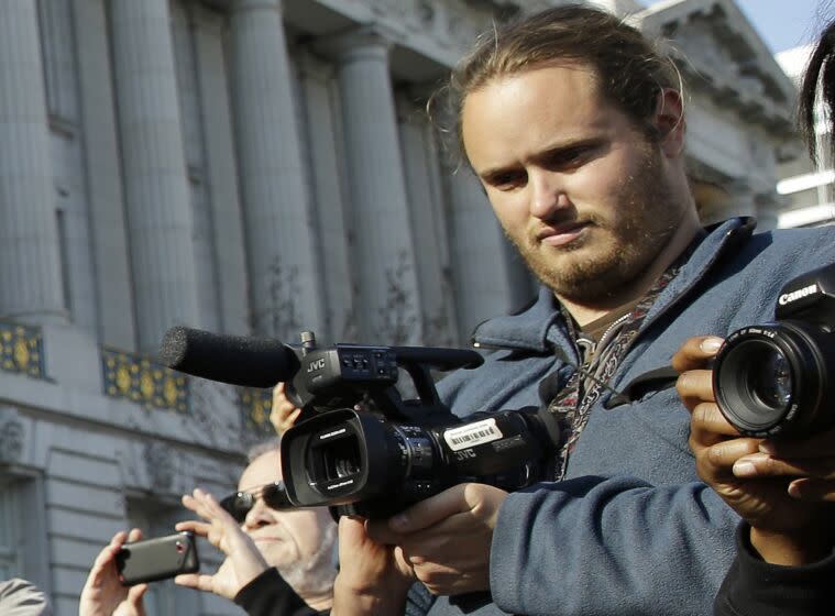 FILE - David DePape, right, records the nude wedding of Gypsy Taub outside City Hall on Dec. 19, 2013, in San Francisco. DePape, who is already in custody in last month's attack on Paul Pelosi, husband of U.S. House Speaker Nancy Pelosi, was indicted Wednesday, Nov. 9, 2022, by a federal grand jury on charges of assault and attempted kidnapping. (AP Photo/Eric Risberg, File)