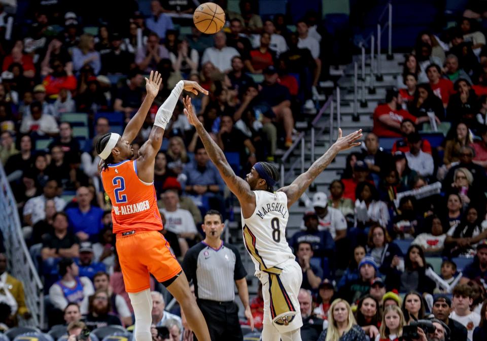 Oklahoma City Thunder guard Shai Gilgeous-Alexander (2) shoots over New Orleans Pelicans forward Naji Marshall (8) during the second quarter of an NBA basketball game in New Orleans, Saturday, March 11, 2023. (AP Photo/Derick Hingle)