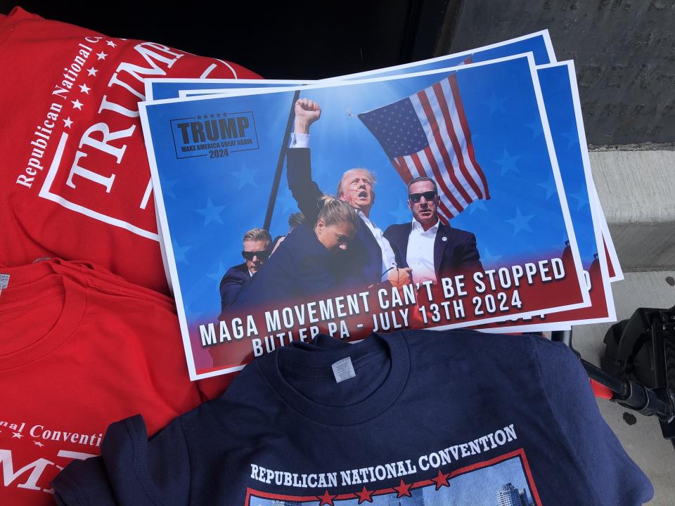 A vendor is selling merchandise that includes a photo of Donald Trump after he survived an assassination attempt in Pennsylvania.