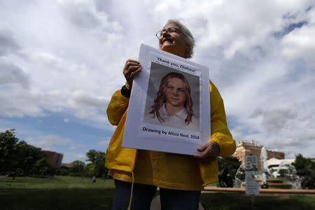 A woman takes part in a small rally in support of Chelsea Manning in Kansas City, Missouri, U.S. May 17, 2017. REUTERS/Carlo Allegri