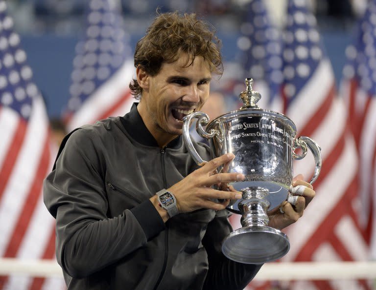 Rafael Nadal of Spain celebrates with the trophy following victory over Novak Djokovic of Serbia in their 2013 US Open men's singles final match at the USTA Billie Jean King National Tennis Center in New York on September 9, 2013. Nadal won 6-2, 3-6, 6-4, 6-1