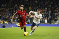 Liverpool's Mohamed Salah, left, challenges for the ball with Tottenham's Ben Davies during the English Premier League soccer match between Tottenham Hotspur and Liverpool at Tottenham Hotspur Stadium, in London, Sunday, Nov. 6, 2022. (AP Photo/David Cliff)