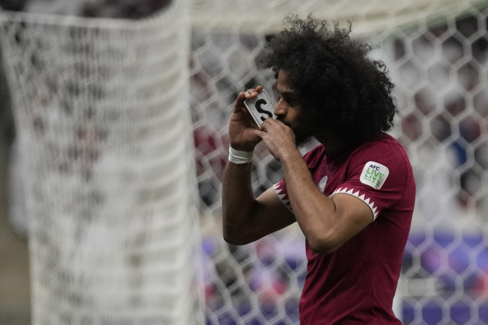 Qatar's Akram Afif celebrates after scoring his side's opening goal during the Asian Cup final soccer match between Qatar and Jordan at the Lusail Stadium in Lusail, Qatar, Saturday, Feb. 10, 2024. (AP Photo/Aijaz Rahi)