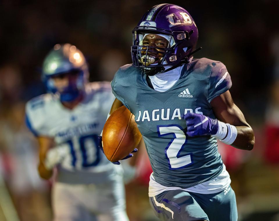 LBJ receiver/safety Fatu Mukuba, scoring a touchdown this season against McCallum, often speaks to his brother Andrew, now a safety at Clemson. He said he considers Jahmal Fenner a coach and a mentor.