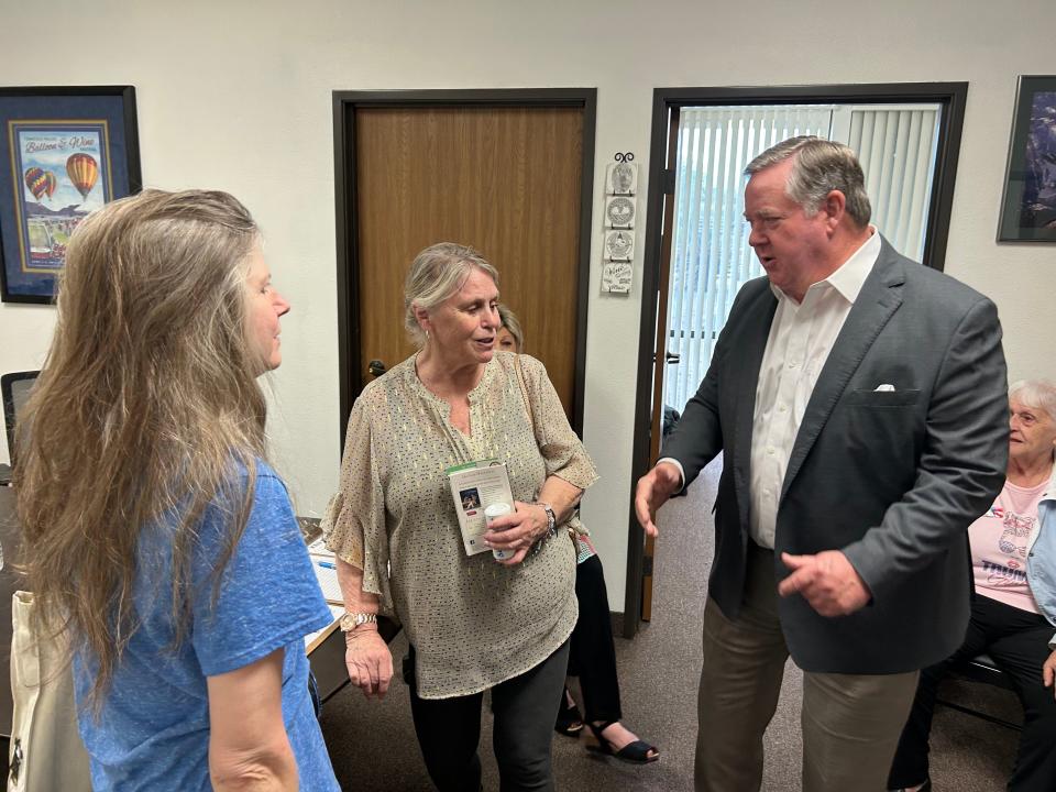 Rep. Ken Calvert, who newly represents several valley cities in Congress, speaks with constituents at a grand opening of his office in Palm Desert on Monday.