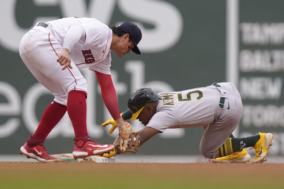 Oakland Athletics' Tony Kemp (5) steals second base as Boston Red Sox's Yu Chang, left, tries to tag him in the fourth inning of a baseball game, Sunday, July 9, 2023, in Boston. (AP Photo/Steven Senne)
