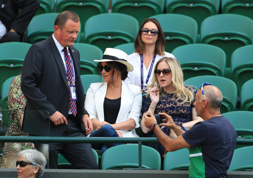 Previously unissued picture dated 4/7/2019 of a man believed to be a Royal bodyguard approaching a spectator who had taken a selfie as the Duchess of Sussex watches the Serena Williams match on court one during day four of the Wimbledon Championships at the All England Lawn Tennis and Croquet Club, Wimbledon. (Photo by Mike Egerton/PA Images via Getty Images)