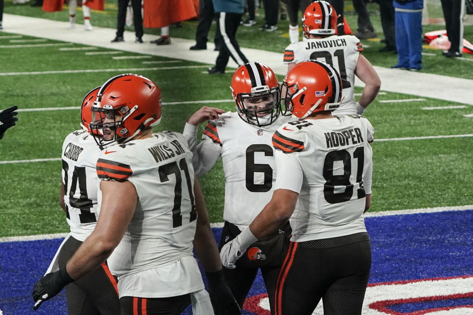 Cleveland Browns quarterback Baker Mayfield (6) celebrates with teammate Austin Hooper (81) after they connect for a touchdown during the first half of an NFL football game against the New York Giants, Sunday, Dec. 20, 2020, in East Rutherford, N.J. (AP Photo/Seth Wenig)