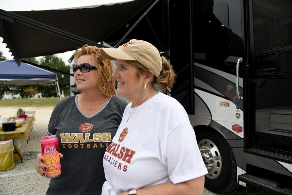 Proud moms Kelly Bischof and Sharon Francz enjoy pregame fun before their sons Kyle Bischof and Connor Francz take the field Saturday in Walsh University's first regular-season football game at Larry Staudt Field.