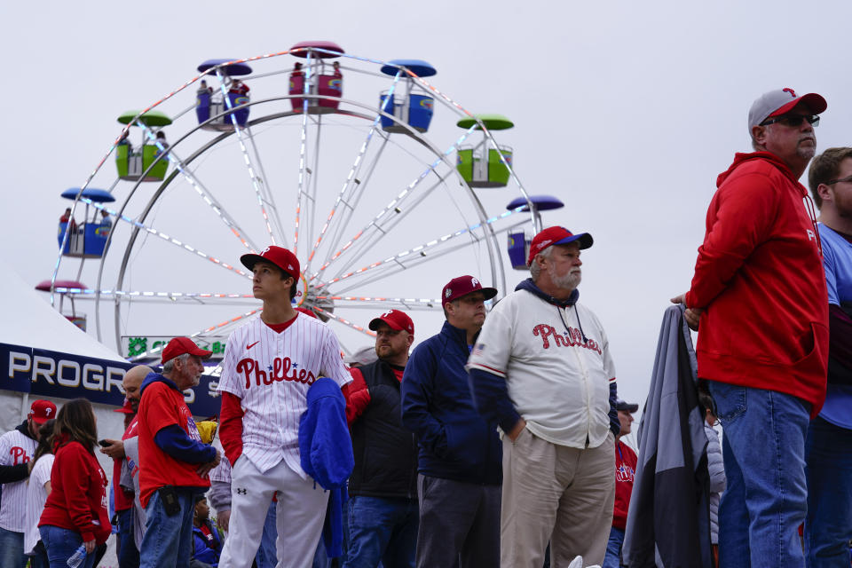 Fans arrive Game 3 of baseball's World Series between the Houston Astros and the Philadelphia Phillies on Monday, Oct. 31, 2022, in Philadelphia. The game was postponed by rain Monday night with the matchup tied 1-1. (AP Photo/Matt Rourke)