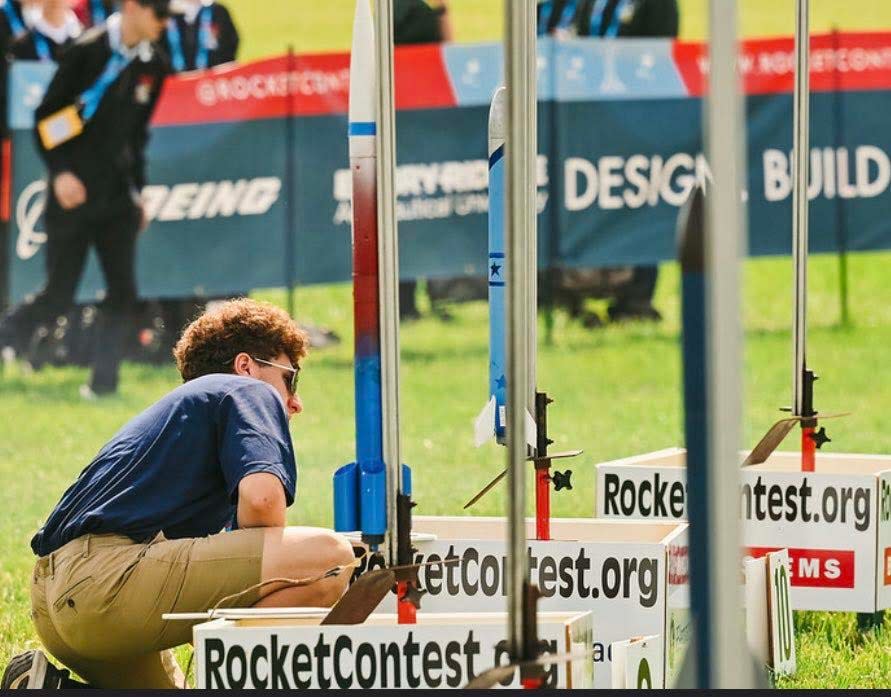 Zaen Grissino-Mayer, AeroHAWKS team manager from Hardin Valley Academy, adjusts the National Championship Rocket at the American Rocketry Challenge held at Great Meadow in The Plains, Va. April 2023.