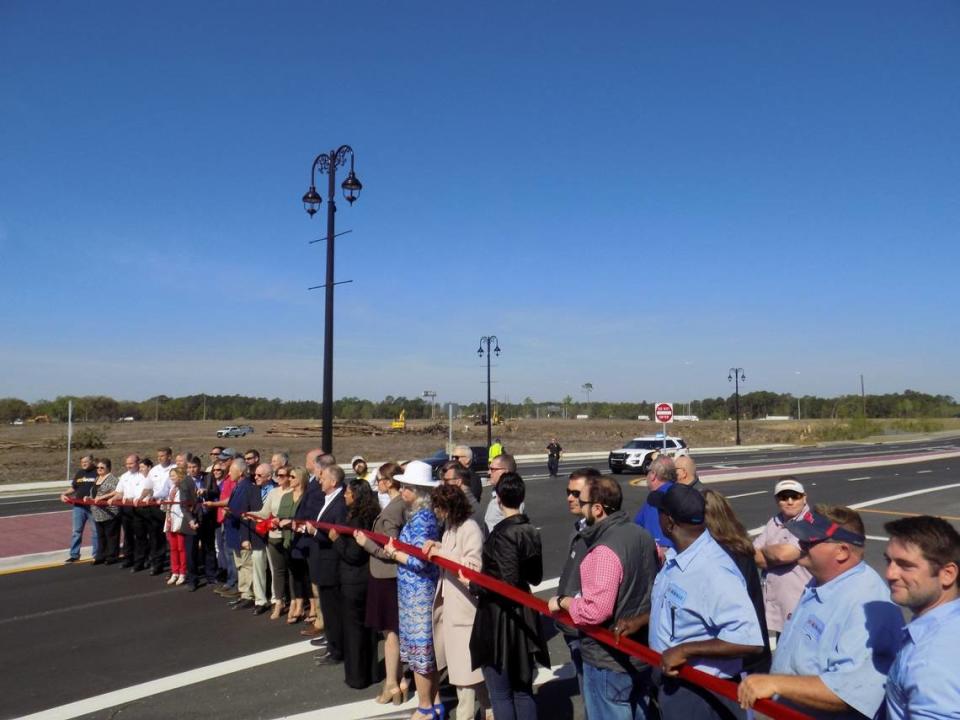 As a big group prepares to cut the ribbon on improvements to D’Iberville Boulevard in 2019, heavy equipment clears the adjacent land for more development in D’Iberville. A Sports Illustrated Resort is planned for the site.