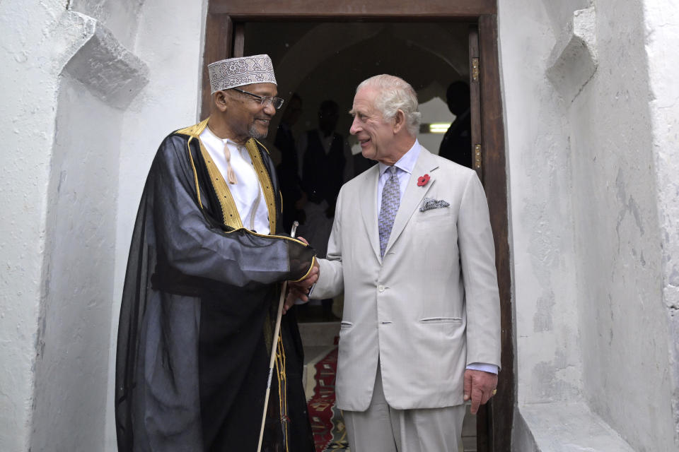 Britain's King Charles III, right, shakes hands with Chairperson of the Mandhry Mosque Committee Babu Ali Said during a visit to Al-Mandhry at Mahandry Mosque in Mombasa, Kenya, Friday Nov. 3, 2023. (Simon Maina/Pool via AP)