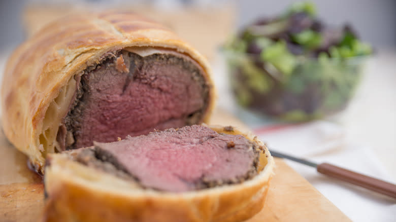 A slice cut from beef Wellington revealing interior