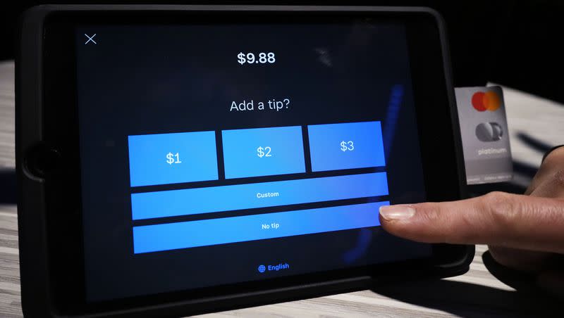 A tipping option is displayed on a card reader tablet at a business in Glenview, Ill., Tuesday, Jan. 10, 2023. Consumers have expressed anger over self-checkout kiosks asking for tips. 