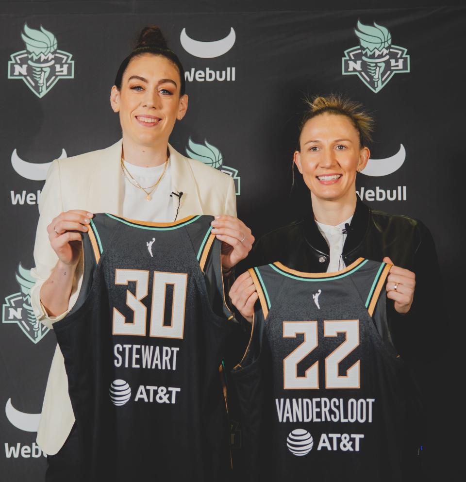 Breanna Stewart (left) and Courtney Vandersloot pose with their new jerseys.