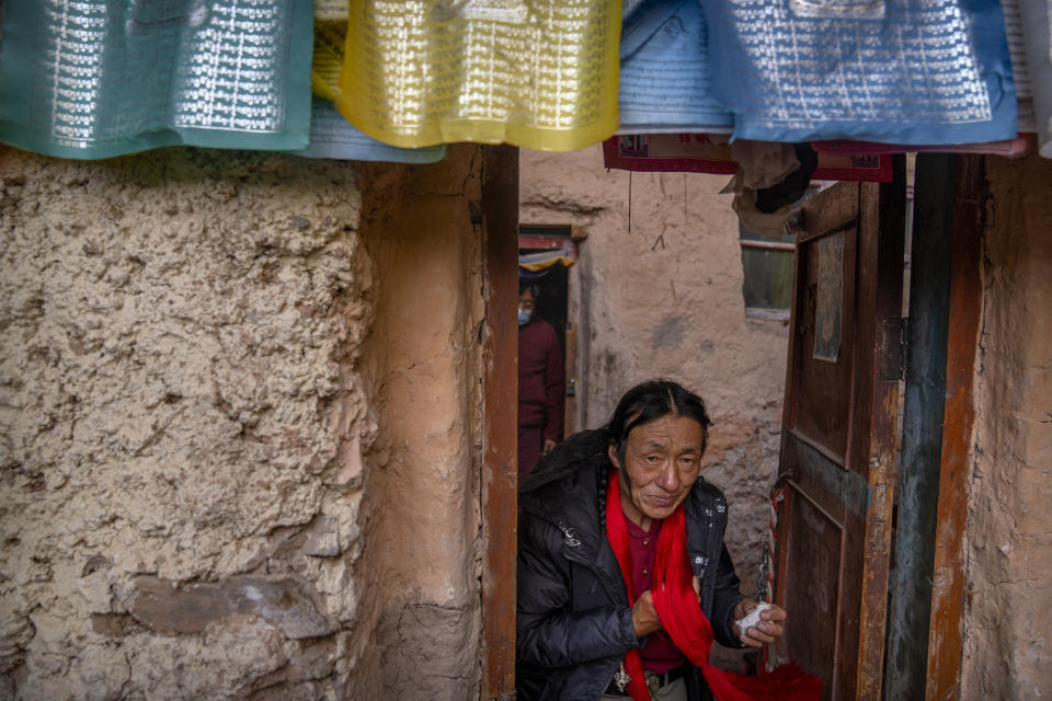 A Tibetan man leaves a Buddhist holy site built in a grotto in Namtso in western China's Tibet Autonomous Region, Wednesday, June 2, 2021, as seen during a government organized visit for foreign journalists. High-pressure tactics employed by China's ruling Communist Party appear to be finding success in separating Tibetans from their traditional Buddhist culture and the influence of the Dalai Lama. (AP Photo/Mark Schiefelbein)