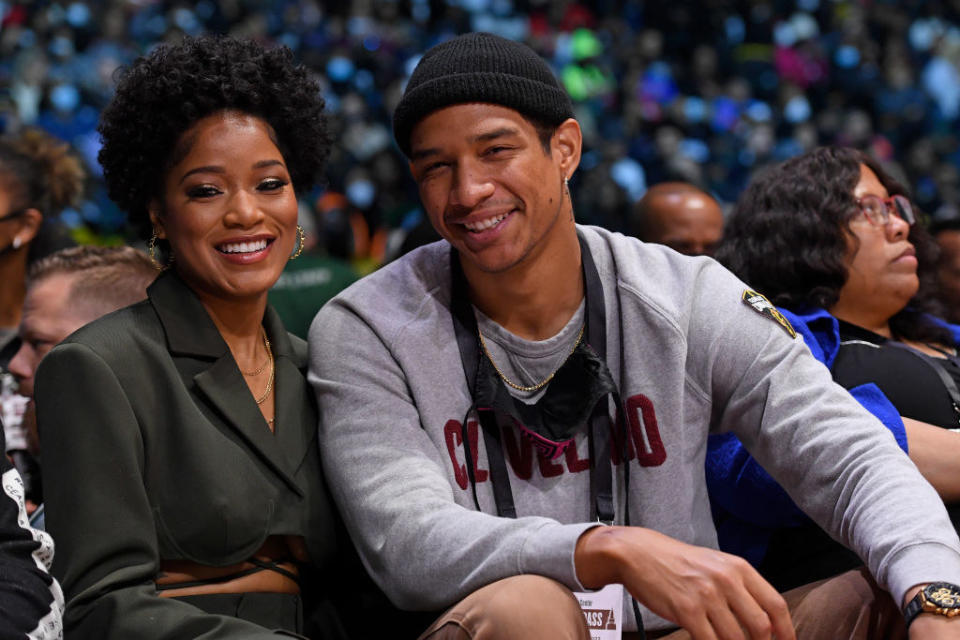 Keke, on the left, sitting with Darius at an event as they smile for a photo