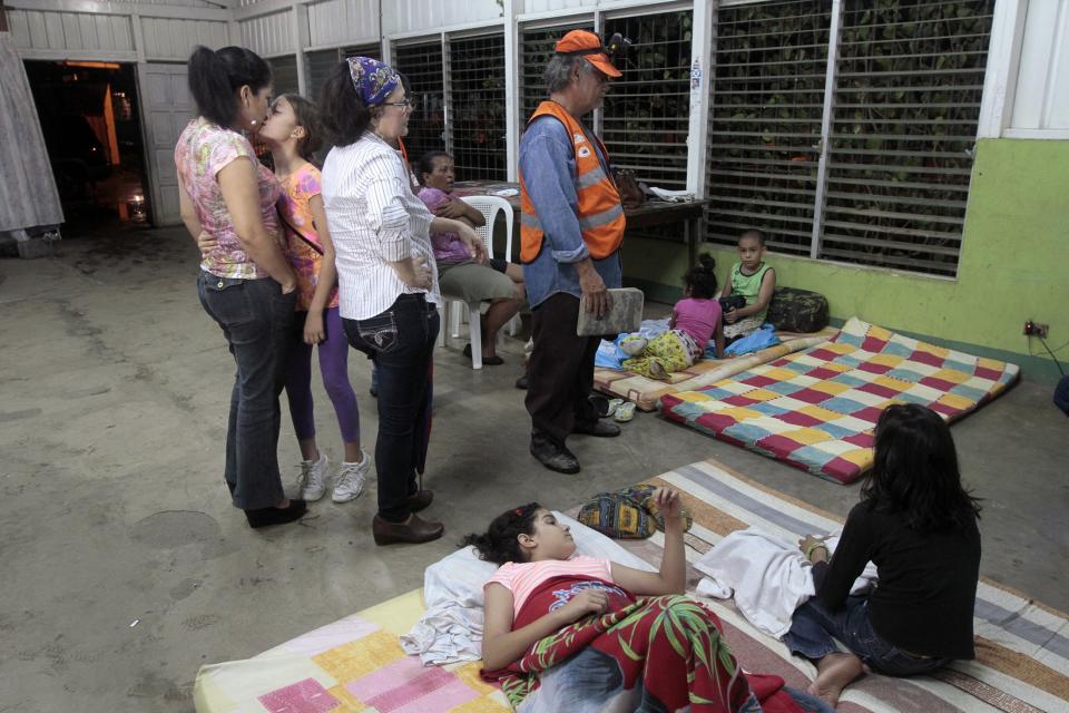 People stand inside an evacuation center in Managua after an earthquake shook Nicaragua October 13, 2014. (REUTERS/Oswaldo Rivas)
