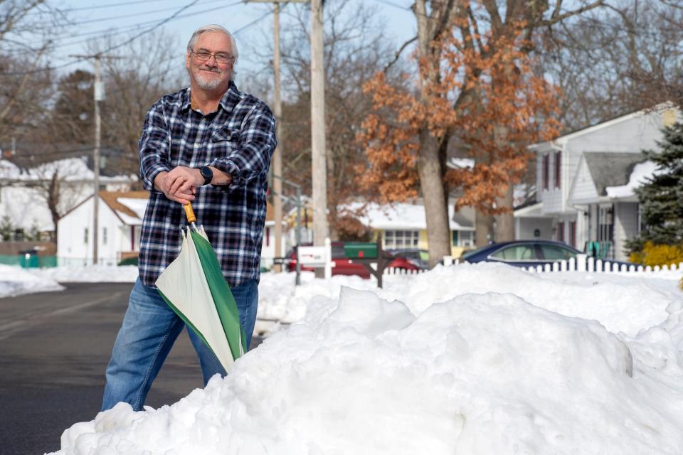 Bob Burger of Point Pleasant Borough and a retired police chief who runs a widely followed Facebook page where he posts weather forecasts, stands in the snow outside of his home in Point Pleasant Borough, NJ Tuesday, February 2, 2022. 