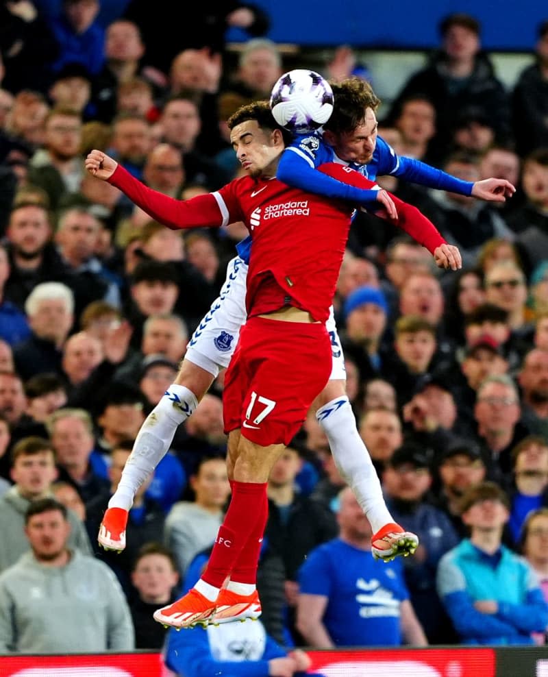 Liverpool's Curtis Jones (L) and Everton's James Garner battle for the ball during the English Premier League soccer match between Everton and Liverpool at Goodison Park. Peter Byrne/PA Wire/dpa