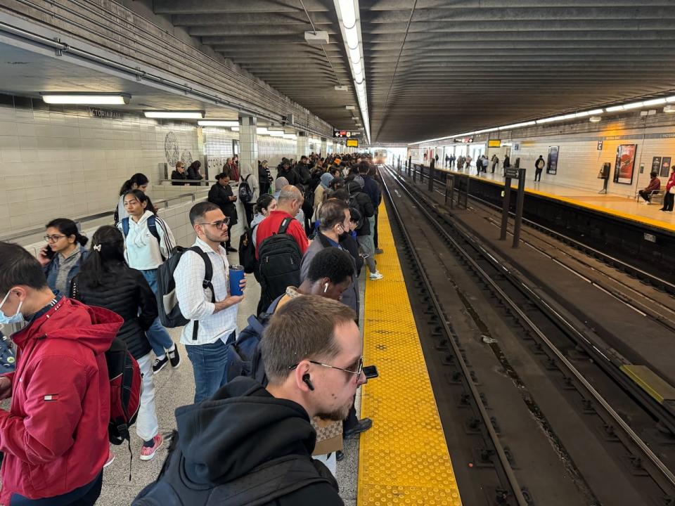 Passengers can be seen inside Victoria Park subway station, where westbound trains are turning back on Line 2 due to a mechanical failure.