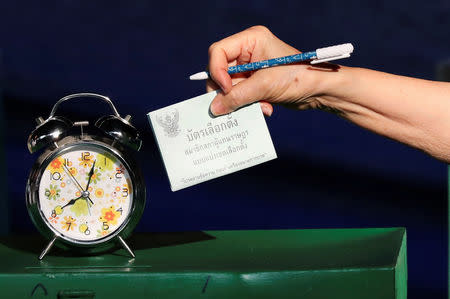 A voter casts their ballot as they vote at a polling station during the general election in Bangkok, Thailand, March 24, 2019. REUTERS/Athit Perawongmetha