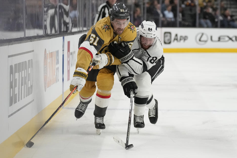 Vegas Golden Knights right wing Mark Stone (61) vies for the puck with Los Angeles Kings defenseman Vladislav Gavrikov (84) during the second period of an NHL hockey game Wednesday, Nov. 8, 2023, in Las Vegas. (AP Photo/John Locher)