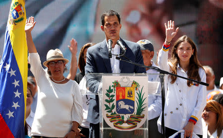 Venezuelan opposition leader Juan Guaido, who many nations have recognized as the country's rightful interim ruler, speaks next to his mother Norka Marquez and his wife Fabiana Rosales, as he attends a rally to commemorate the Day of the Youth and to protest against Venezuelan President Nicolas Maduro's government in Caracas, Venezuela February 12, 2019. REUTERS/Carlos Garcia Rawlins