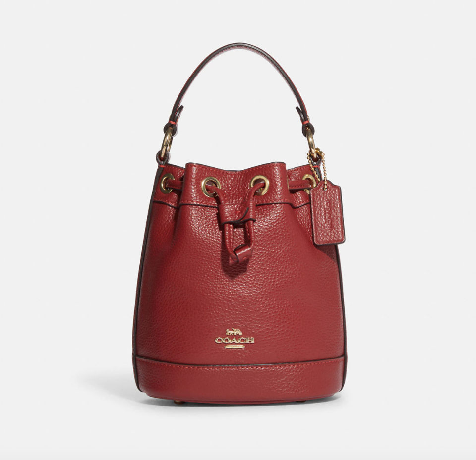 Coach Outlet Dempsey Drawstring Bucket Bag in 1941 red (Photo via Coach Outlet)