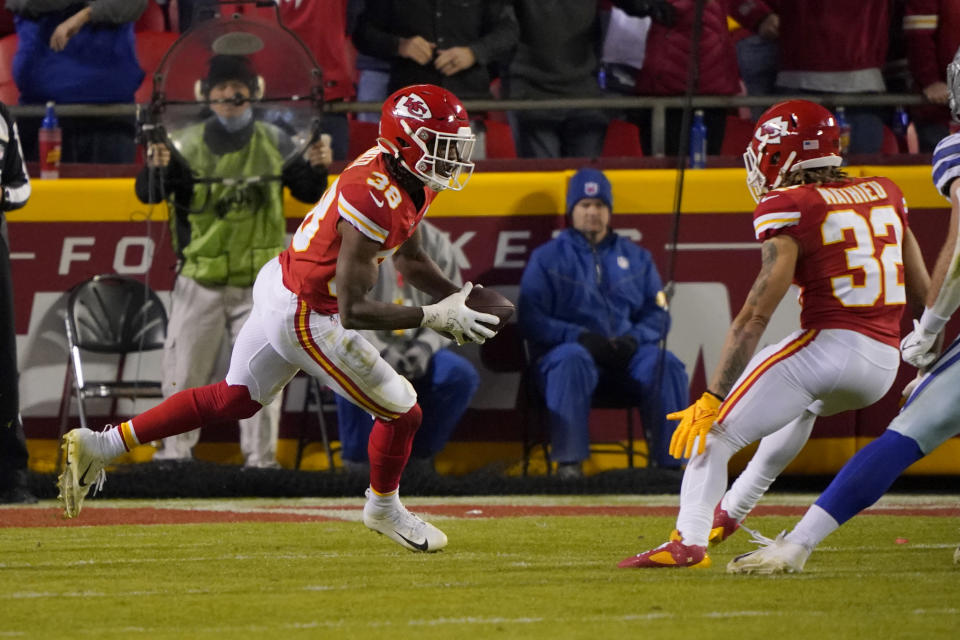 Kansas City Chiefs cornerback L'Jarius Sneed (38) intercepts a pass as teammate Tyrann Mathieu (32) watches late in the second half of an NFL football game against the Dallas Cowboys Sunday, Nov. 21, 2021, in Kansas City, Mo. (AP Photo/Ed Zurga)