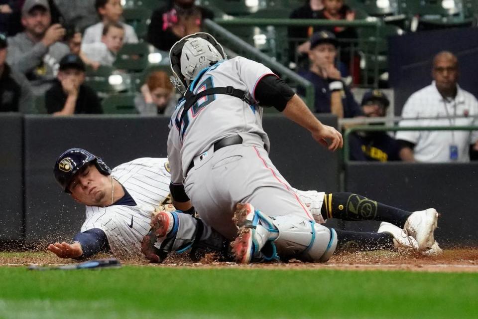 Milwaukee Brewers’ Luis Urias, left, is tagged out at home by Miami Marlins’ Jacob Stallings during the 10th inning of a baseball game Sunday, Oct. 2, 2022, in Milwaukee. (AP Photo/Aaron Gash)