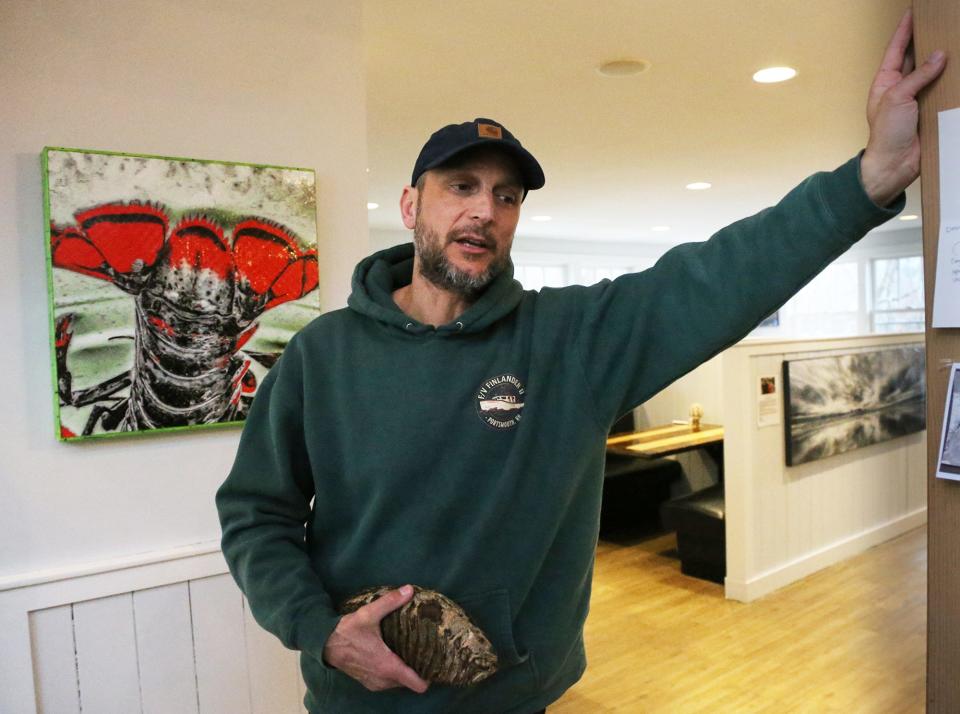 New England Fishmongers Capt. Tim Rider holds a woolly mammoth tooth fossil found in the waters off Newburyport in December.  Rider wants to auction off the tooth and donate all the proceeds to benefit Ukrainian citizens suffering from the war in their country.