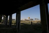 A Palestinian walks past the ruins of Yasser Arafat International Airport, which was bombed by Israel in the past, in Rafah in the southern Gaza Strip February 5, 2016. REUTERS/Ibraheem Abu Mustafa