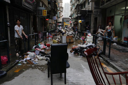 A man reacts in front of his store after Typhoon Hato hit in Macau, China August 24, 2017. REUTERS/Tyrone Siu