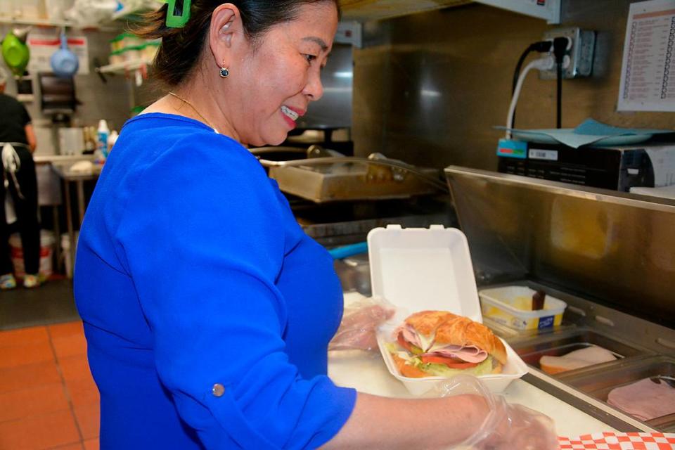 Sovanna’s Donuts owner and namesake Sovanna Lam fixes a sandwich in her Gustine, California, shop May 19, 2023.