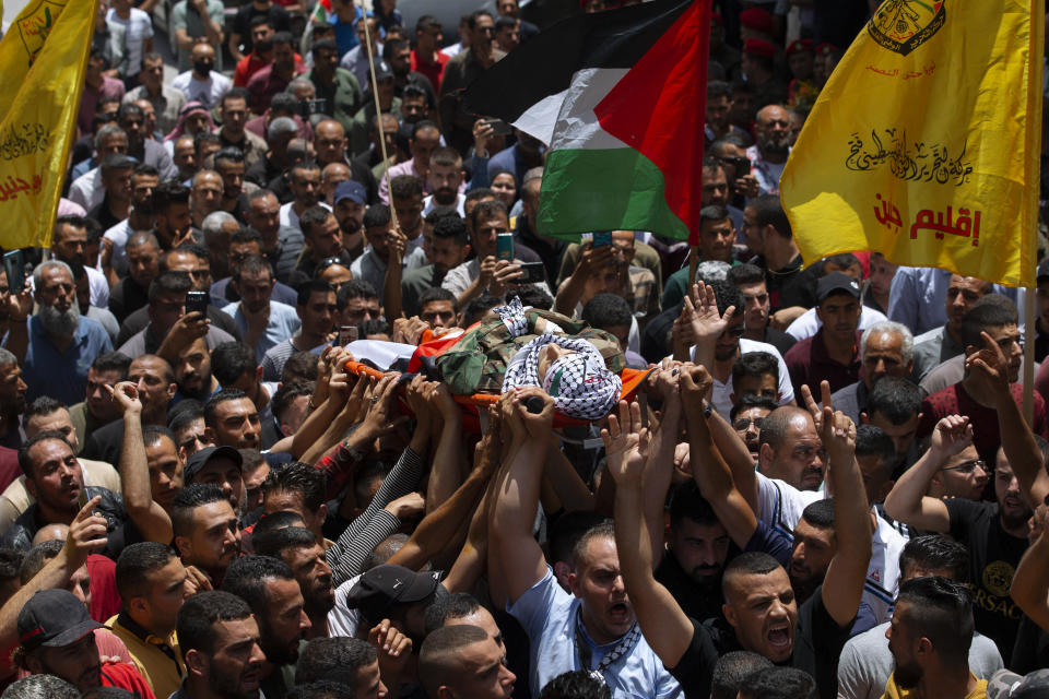 Palestinian mourners carry body of Palestinians security officer, Tayseer Issa, in the West Bank city of Jenin, Thursday, June 10, 2021. Israeli troops shot and killed three Palestinians, including two security officers, in a shootout that erupted in the West Bank town of Jenin during what appeared to be an Israeli arrest raid overnight, Palestinian officials said Thursday. (AP Photo/Majdi Mohammed)