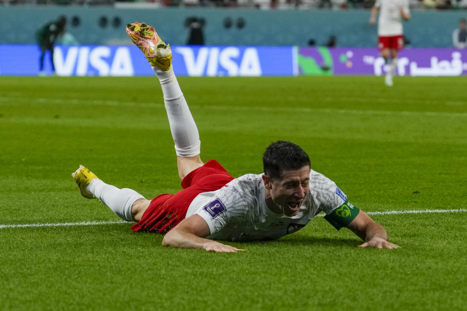 Poland's Robert Lewandowski celebrates scoring his side's 2nd goal during the World Cup group C soccer match between Poland and Saudi Arabia, at the Education City Stadium in Al Rayyan , Qatar, Saturday, Nov. 26, 2022. (AP Photo/Manu Fernandez)