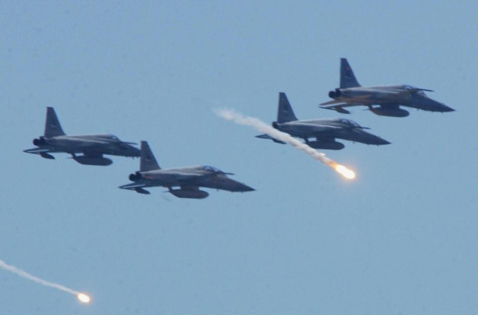 ROCAF F-5Es release flares during a rehearsal at Li Tse Chien beach in Ilan county, northern Taiwan, in August 2003. <em>SAM YEH/AFP via Getty Images</em>