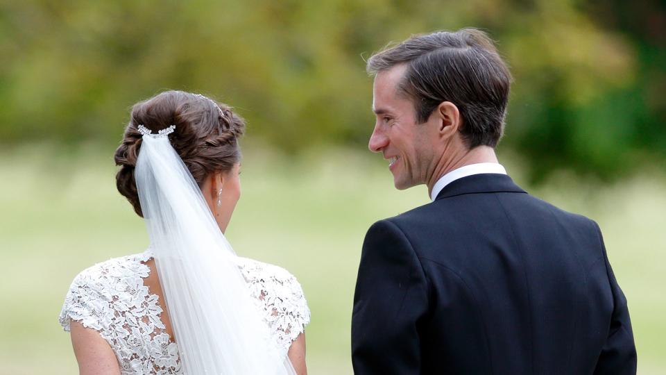 Pippa's wedding hair in a low bun next to james