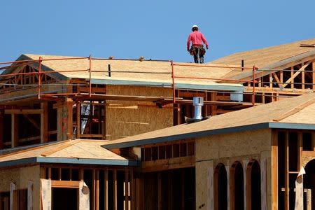 Workers are shown building luxury single family homes in Carlsbad, California, United States May 23, 2016. REUTERS/Mike Blake
